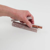 Video of Marble Bars XL Rosso Verona in opaque red natural marble, 1–20 cm long and 8 mm thick, picked up by hand and turned to show their length, colour and natural veining