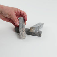 Video of Marble Bars XL Emperador in opaque brown natural marble, 1–20 cm long and 8 mm thick, picked up by hand and turned to show their length, colour and natural veining